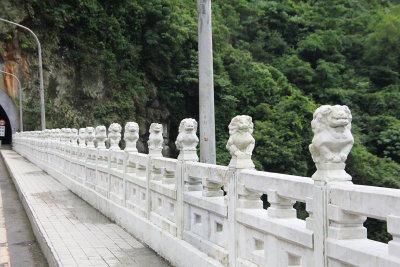 There are other smaller lion statues along the railing of the bridge.