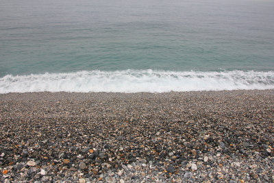 Surf on the rocky beach.