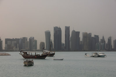 Skyline with wooden boats in the foreground.