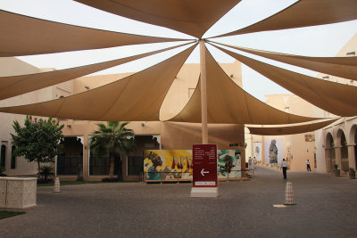 An overhead canopy with a sign showing different exhibits.