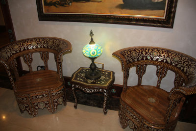 Beautiful chairs with mother of pearl inlay and a traditional lamp.