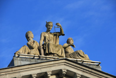 Bronze scales held by Lady Justice on the portico. The courthouse exemplifies Cork's stonework and neoclassical architecture.