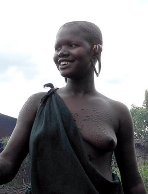 Surma girl with scarification marks and streched ear lobes for plates;  south-western Ethiopia.