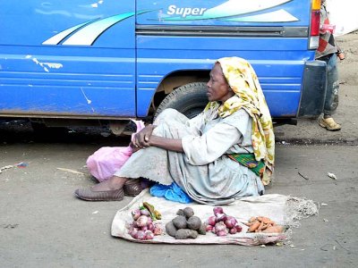 Woman trying to sell a few vegetables in a street of the Mercato area in Addis Ababa. Ethiopia.