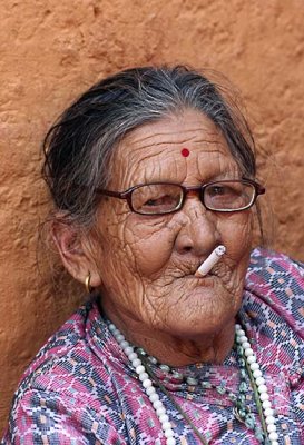 Old lady in Nepal smoking a cigarette