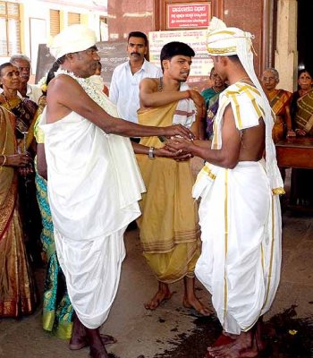 Wedding ceremony in Karnataka, India; the unity between the groom and the brides father is being established