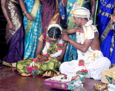 Tying the necklace that she will have to wear till her husband dies. It shows everybody that she is married; Wedding ceremony