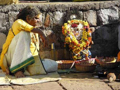 Devadasi with matted hair with a brass bust of goddess Yellamma, Yellamma temple, Saundatti, Karnataka, India