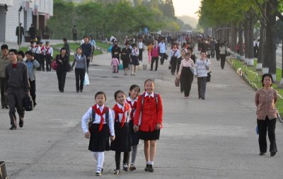 schoolgirls on a busy Pyongyang sidewalk