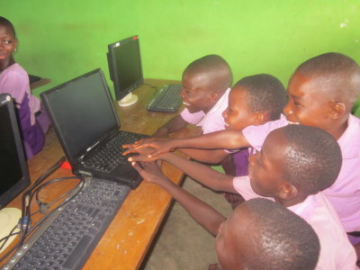 Grade 2 computer students with donated laptop