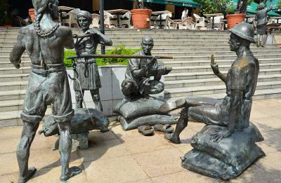 A series of bronze statures depicting Singapore life in the past