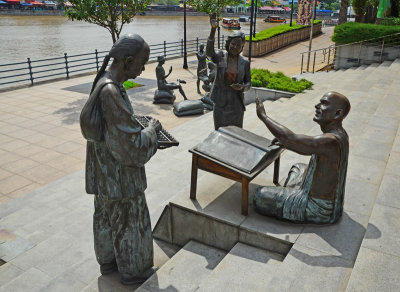 A series of bronze statures depicting Singapore life in the past