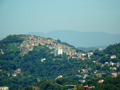 A favela on the mountainside in the distance