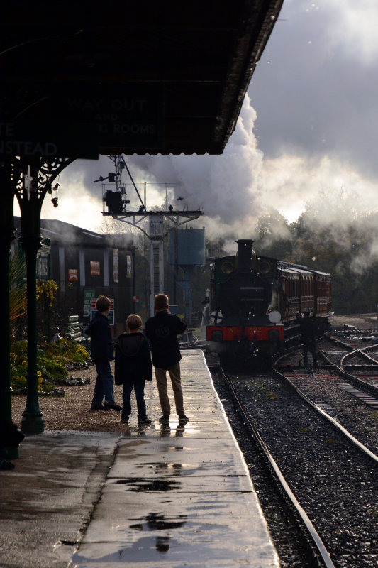 Young steam enthusiasts watching key change over at Horsted Keynes station