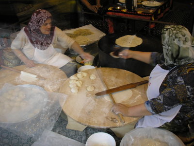 These ladies are rolling out bread with their sticks