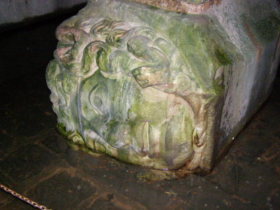 Medusa's head, carved in stone, on her side