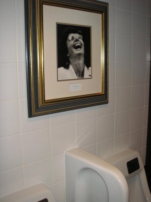 Billie Jean King laughing over the urinals