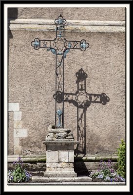 Cross by the wall.