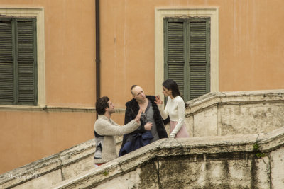 An actor and actress with a make-up man.