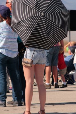 Hiding behind an umbrella.