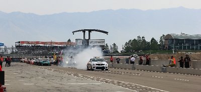 The Cadillac pace car doing a burnout on pit lane.