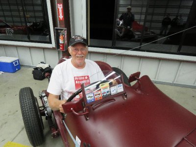 Some crazy old man in a very expensive rare old race car.