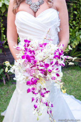 Purple and white dendrobium orchid cascading bouquet. Photos by www.mandjphoto.com