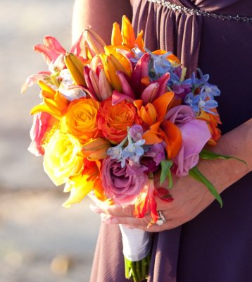 Tropical yellows, oranges, purples and blues bouquet. Photo by Susan Pacek Photography