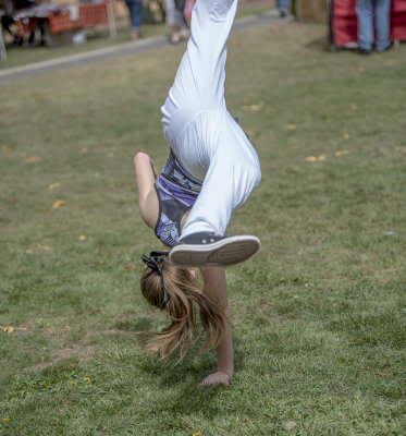 A YOUNG TUMBLER ENTERTAINS THE CROWD