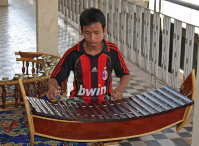 Student playing roneat (xylophone)