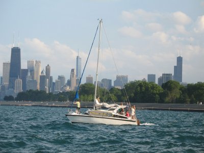 Sailboat heading out with downtown in the background
