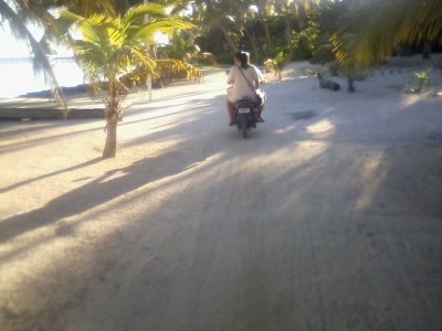 Motorcycle couple on the beach road Ambergris Caye Oct 30 2014
