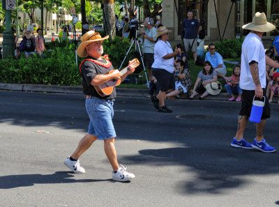 Ukelele player in Pa'u Queen entourage enjoying his stroll