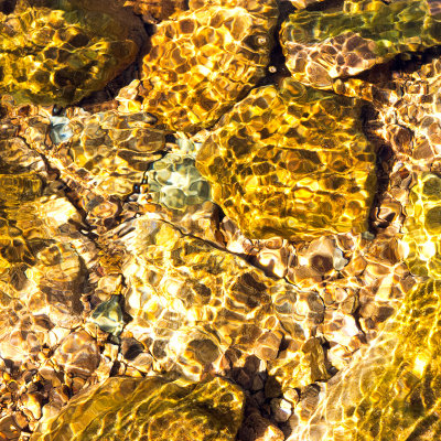 Stones underwater in the sun