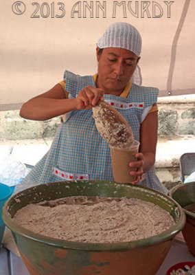 Lady serving up glass of tejate