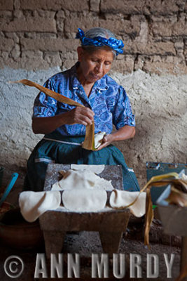 Irene wrapping the tamales with corn leaves