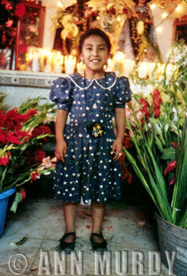 Little Girl in Front of Posada Altar