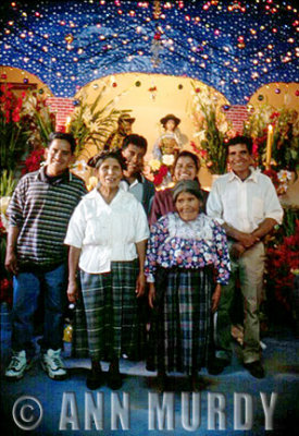 Family in front of posada altar