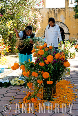 Adding flowers to the grave