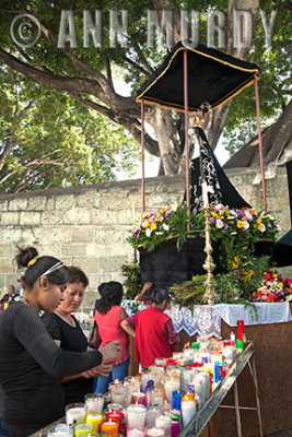 Lighting a candle for the Virgin of Soledad