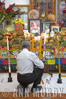 Adding candle to the ofrenda