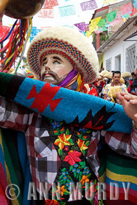 Parachico dancer holding his chinchin