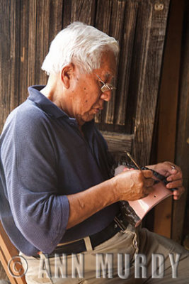 Maestro Antonio working on a mask