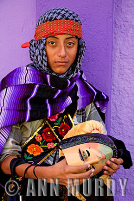 Parachico dancer holding mask