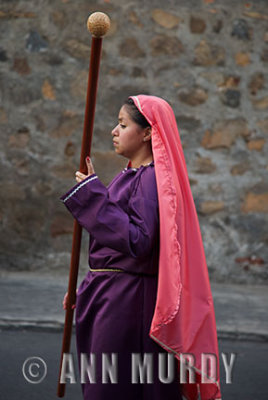 Girl carrying staff in procession