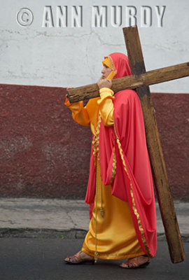 Girl carrying cross in procession