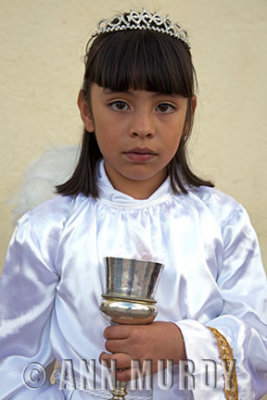 Girl portraying angel in procession