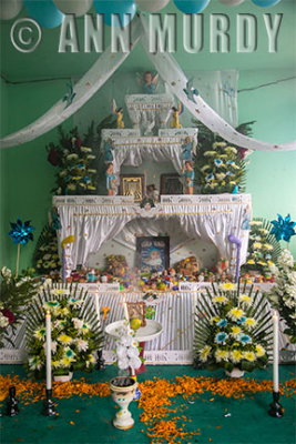 Altar for Gerardo Alexis with lit candles