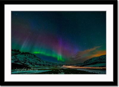Aurora borealis and trail of  car light