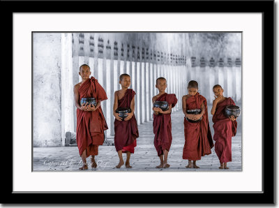 Five young monks in long temple corridor